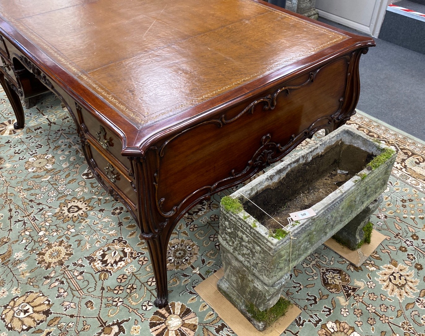 An early 20th century mahogany kneehole partner's desk with tooled tan leather inset top, length 154cm, depth 110cm, height 73cm